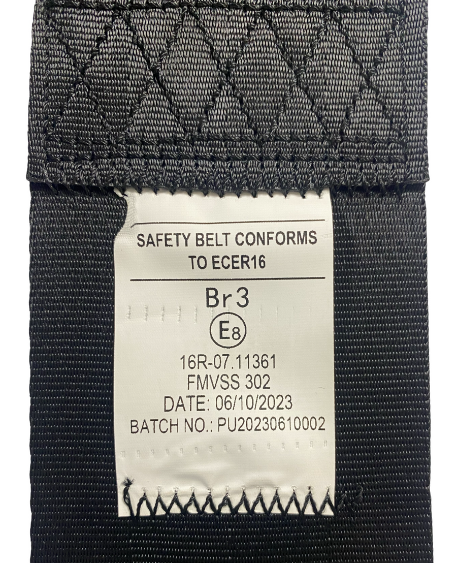 View of SA230 Black retractable lap seatbelt label showing seatbelt has been tested and certified to EU standard ECE R16 and FMVSS 302 safety compliance.
