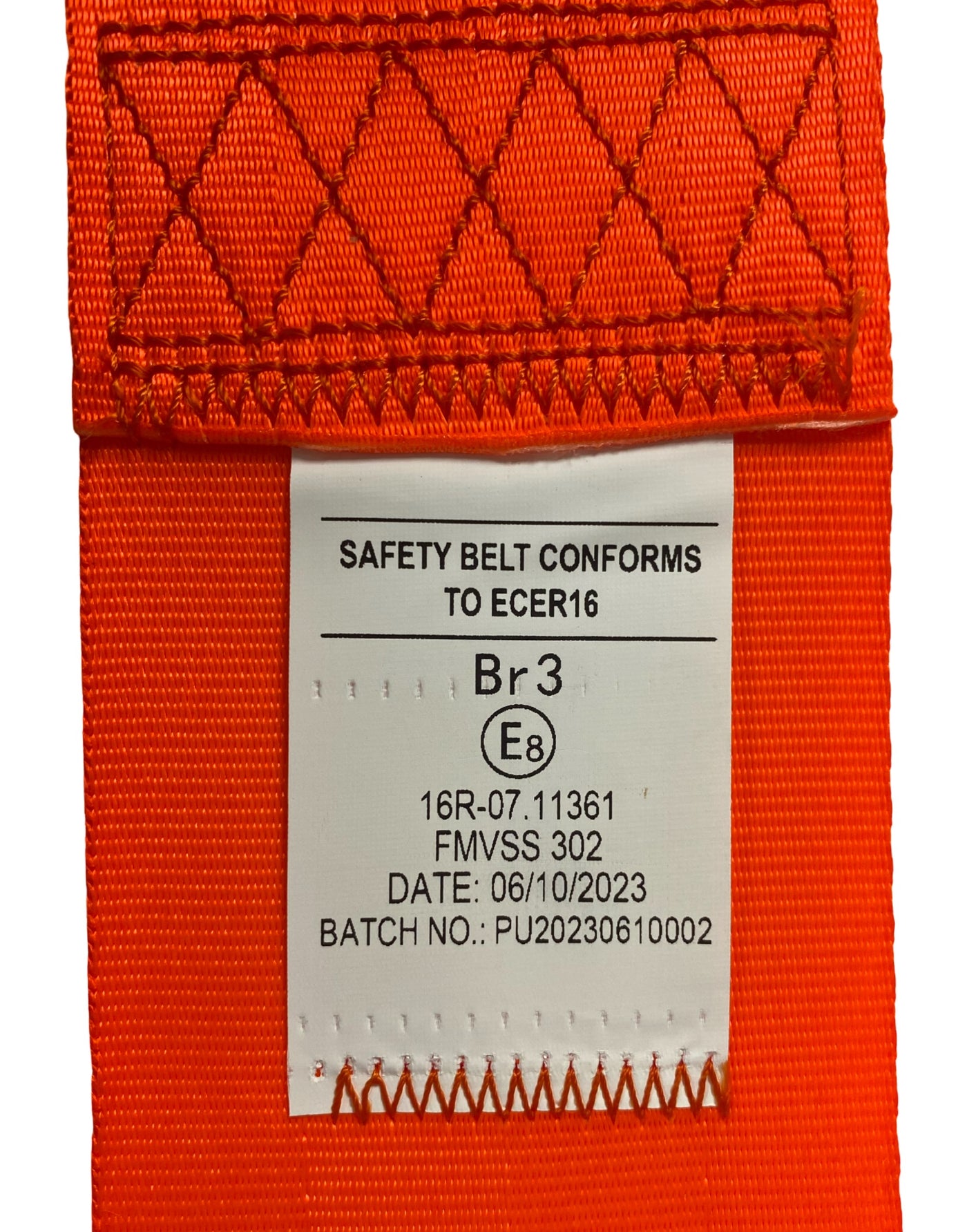 View of SA230 Orange retractable lap seatbelt label showing seatbelt has been tested and certified to EU standard ECE R16 and FMVSS 302 safety compliance.