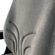 Close-up of durable grey check fabric upholstery used on the SW8UA machinery seat for operator comfort and durability.
