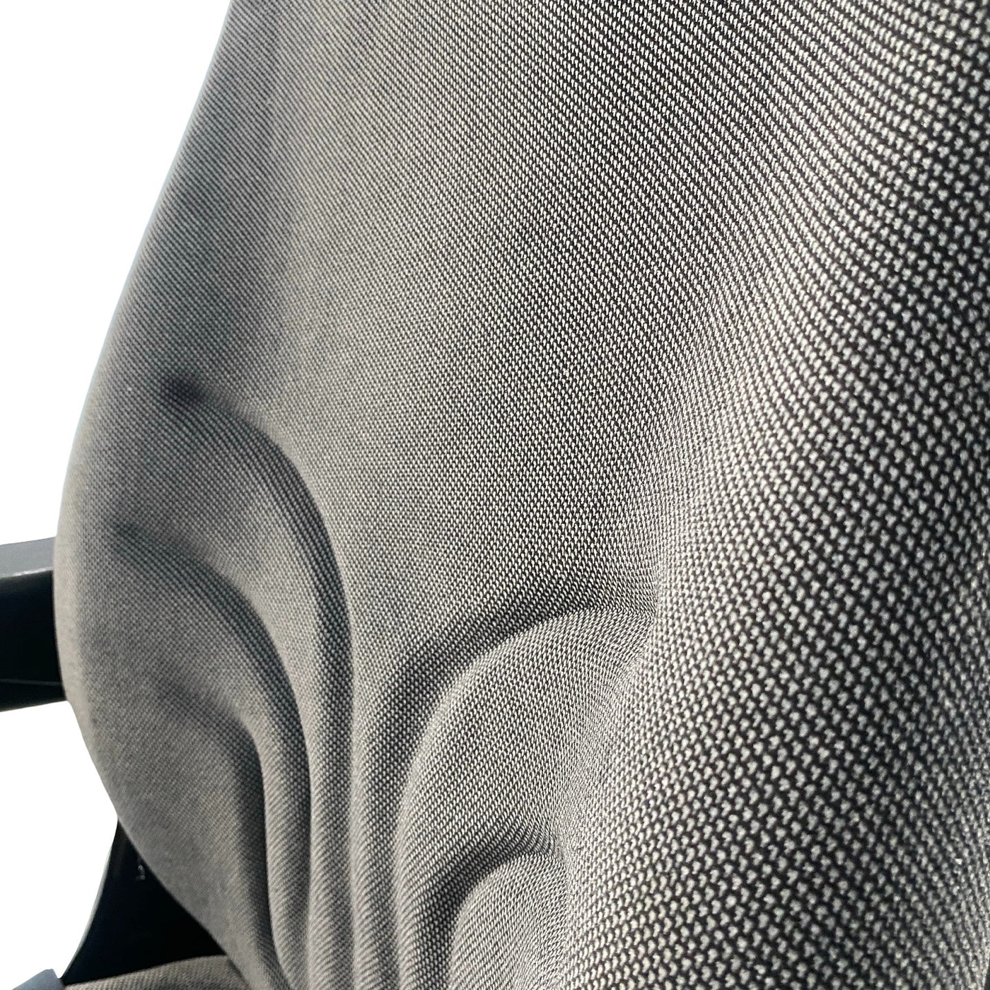 Close-up of durable grey check fabric upholstery used on the SW8UA machinery seat for operator comfort and durability.