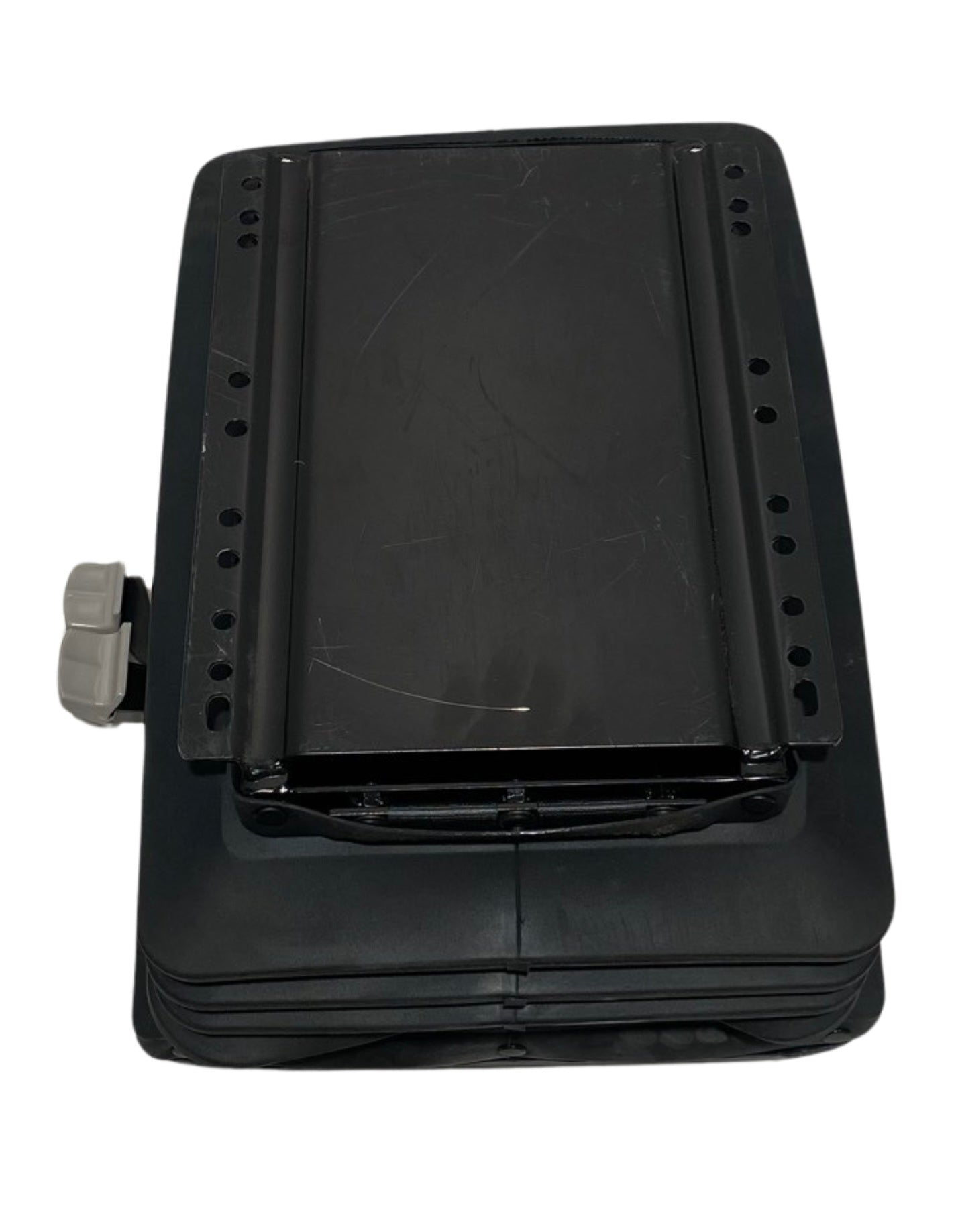 Underside view of SC-BASE mechanical suspension seat base showing multiple floor mounting holes for universal fitment